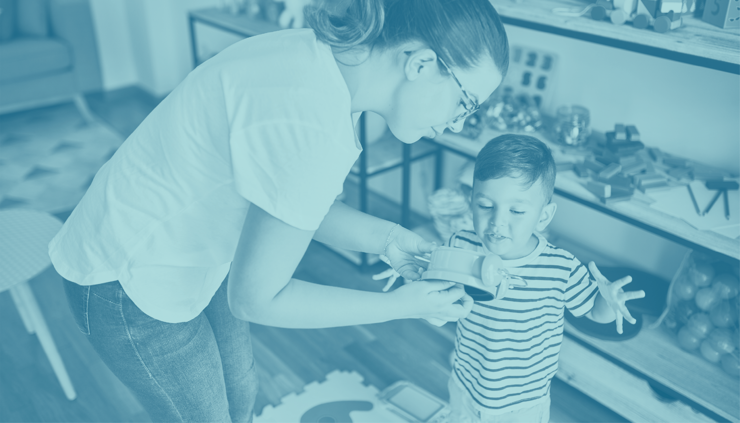 Adult showing object to toddler.