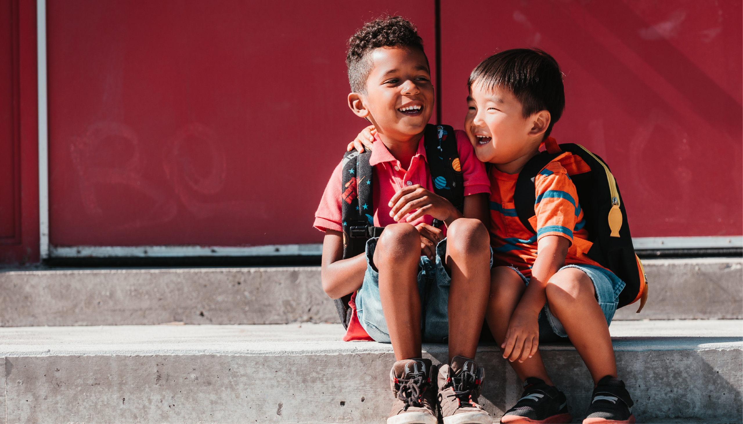 Two young boys sitting next to each other